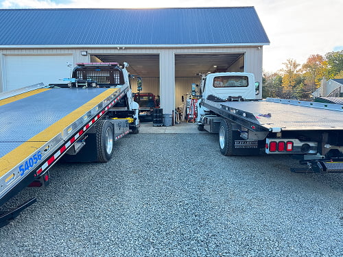two tow trucks side by side